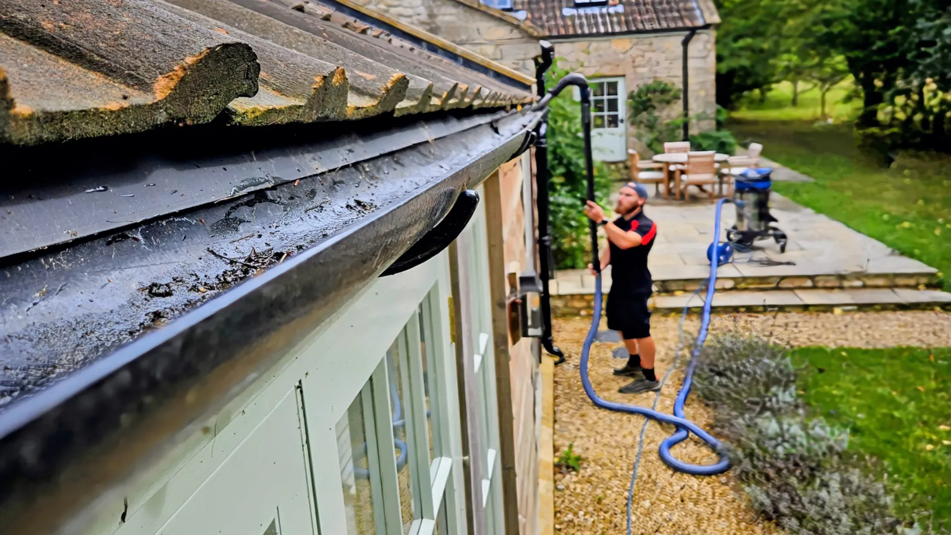 Gutter clearing with a gutter vacuum pole from ground level